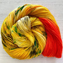 Knitted Wit Herstory 2022 yarn color Mango Street, a yellow/green/orange yarn, spiraled